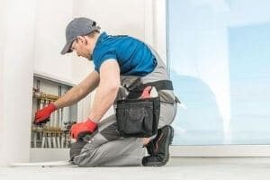 plumber caulking a bathtub